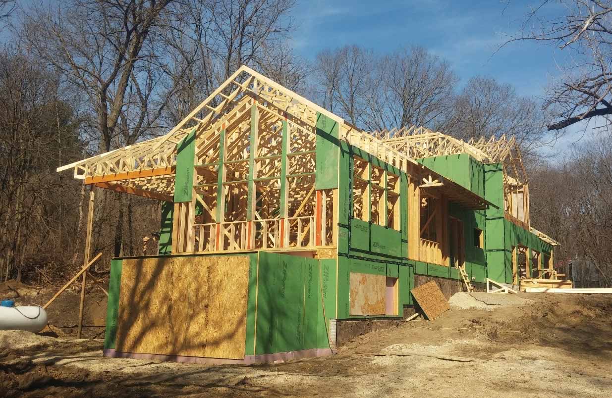 New custom home designed and being built by Silent Rivers of Des Moines, Iowa is framed and partially wrapped