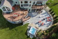 Aerial view of Urbandale backyard entertaining area with deck, patio, spa, curved stairs designed and built by Silent Rivers of Des Moines, Iowa