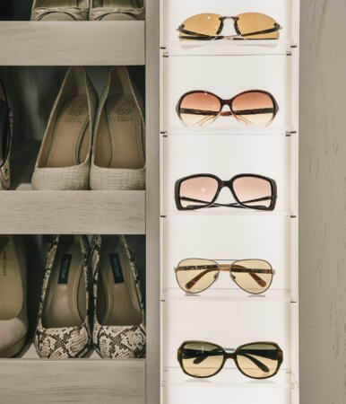 lighted sunglasses and eyewear display shelf and stiletto heels storage shelf in a Granger, Iowa master suite remodel by Silent Rivers of Des Moines