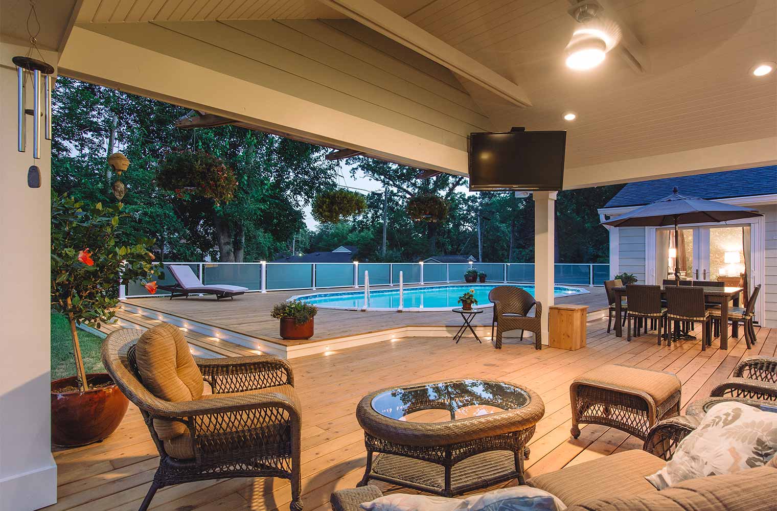covered outdoor entertaining area and patio by pool deck at midcentury ranch home in Des Moines, Iowa by remodeler Silent Rivers