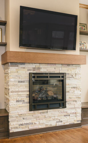 stone hearth, gas fireplace, sleek wood mantel in family room by remodeler Silent Rivers in Clive, Iowa