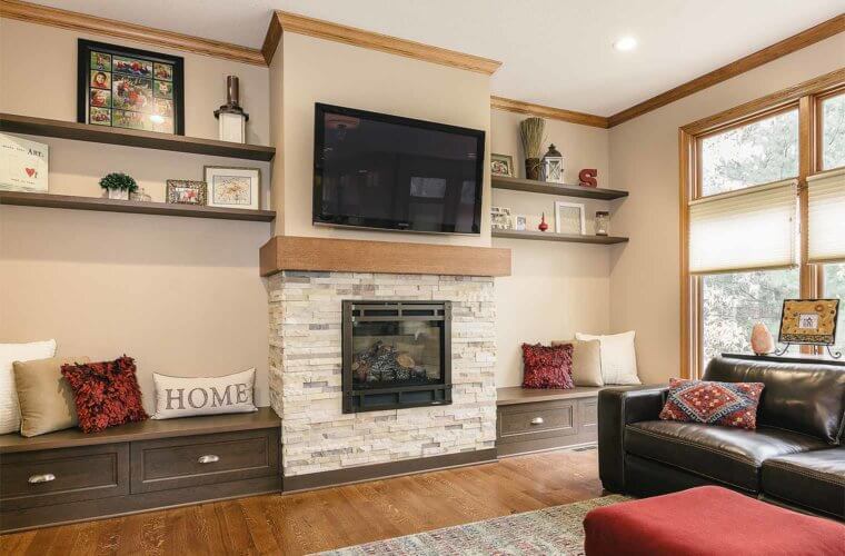 stone fireplace, sleek mantel, custom built-in storage benches in family room remodel by Silent Rivers in Clive, Iowa