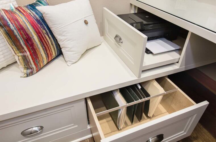 Custom built-in storage cabinets in office nook hold file folders and printer in drawers by remodeler Silent Rivers, Clive, Iowa