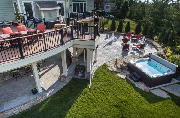 backyard makeover_aerial photo of curved deck, patio and spa by outdoor designer and builder Silent Rivers of Des Moines, Iowa