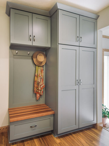 transition white and gray remodel of 1980s galley small kitchen in Des Moines by designer builder Silent Rivers features mudroom locker