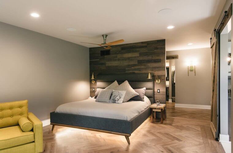 lights under bed frame against wooden slat wall on herringbone floor in master suite remodel by Silent Rivers of Des Moines
