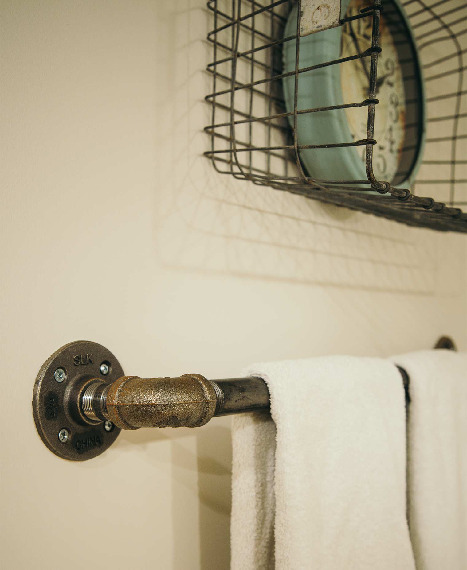 black iron gas pipe parts form a towel bar in Johnston bathroom by remodeler Silent Rivers