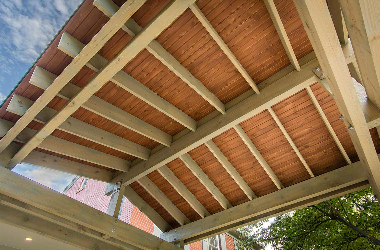 underside of new carport in a warm stain with gray stain timber frame by Silent Rivers