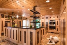 maple and steel cabinets hide storage space in two island kitchen with open space for dog and family to gather in Johnston kitchen by remodeler Silent Rivers