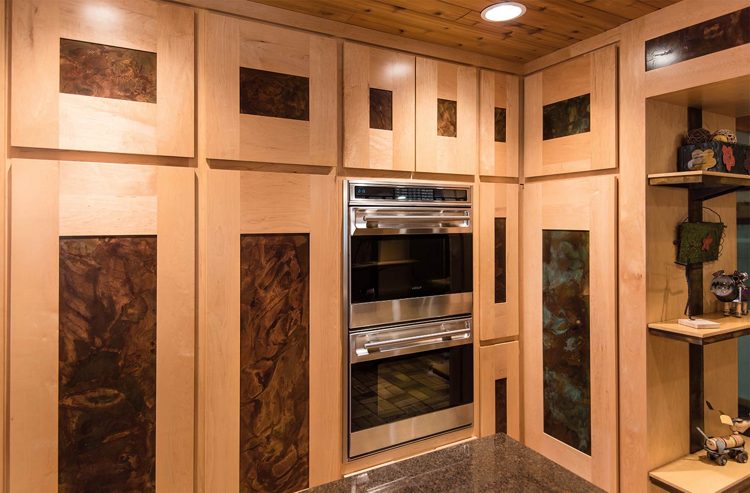 custom maple cabinets with steel patina inlays surround double oven in Johnston kitchen by remodeler Silent Rivers