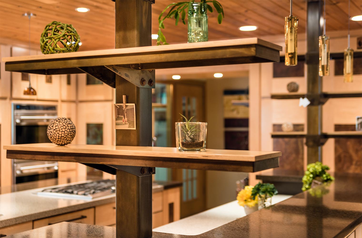 steel and maple shelves extend from the island to the wood ceiling in this Johnston kitchen by remodeler Silent Rivers