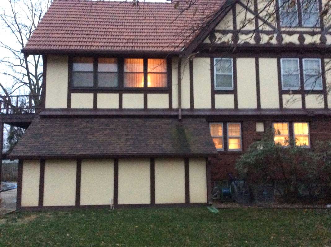 before exterior remodel of Des Moines tudor house shows no access from back of home to pool in backyard