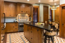 kitchen remodel of historic Victorian Des Moines home by Silent Rivers features curved island, patterned tile floor and soapstone counters