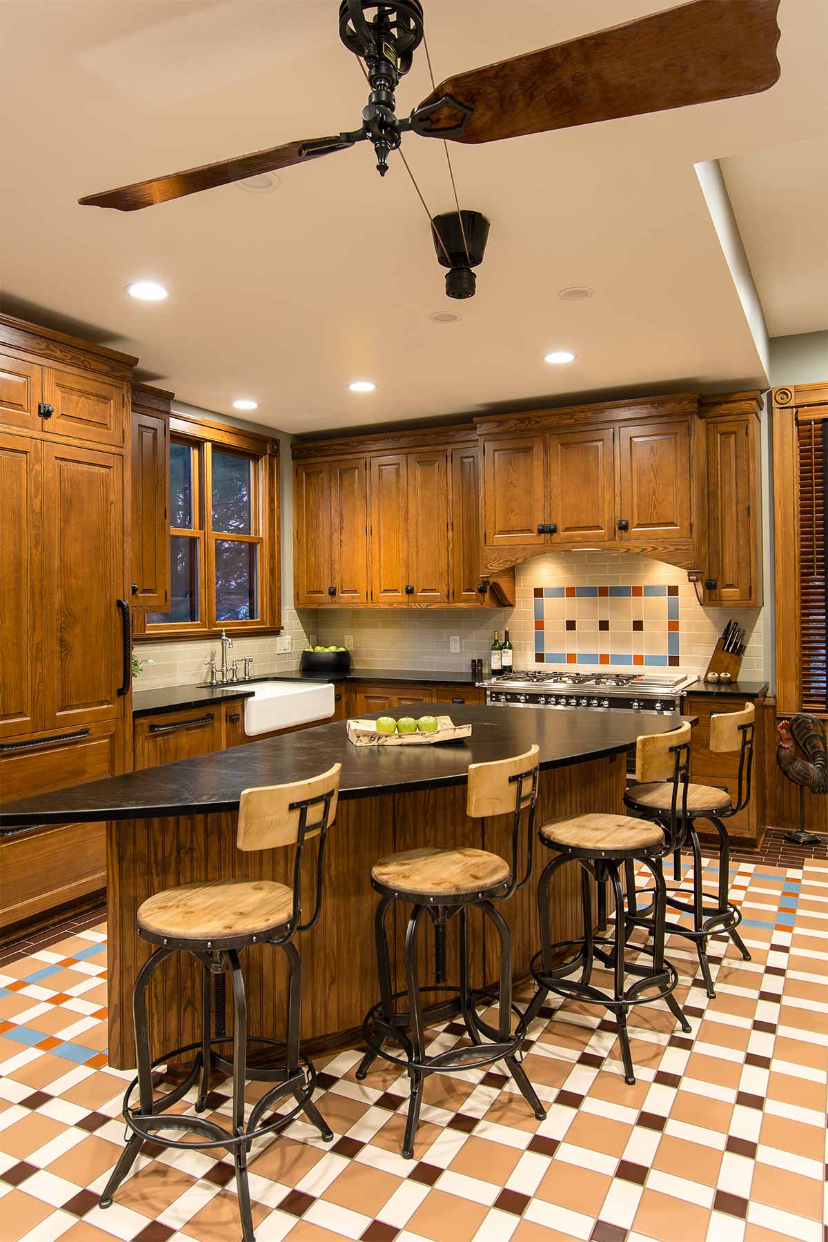 historical kitchen remodel by Silent Rivers in Des Moines Victorian home features custom victorian kitchen cabinets concealing refrigerator and dishwasher and belt-driven fan