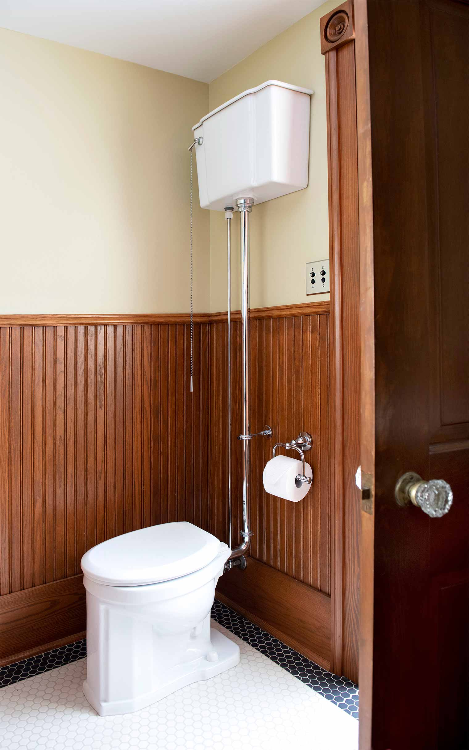 bathroom remodel in a Des Moines Victorian home renovation by Silent Rivers features tank style toilet