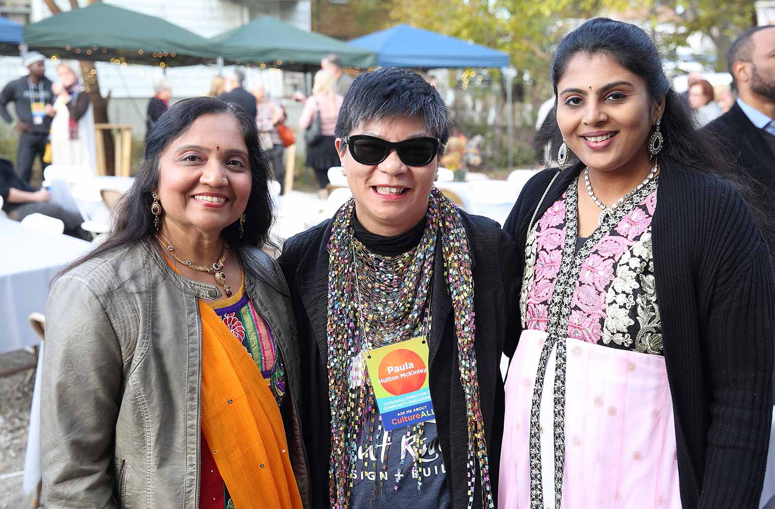 CultureALL Ambassadors Sonal Mistry (left) and Pragnya Yogesh (right) pose with CultureALL Community Engagement Director Paula Hutton McKinley (middle) at Silent Rivers 25th anniversary and dsm Unveiling