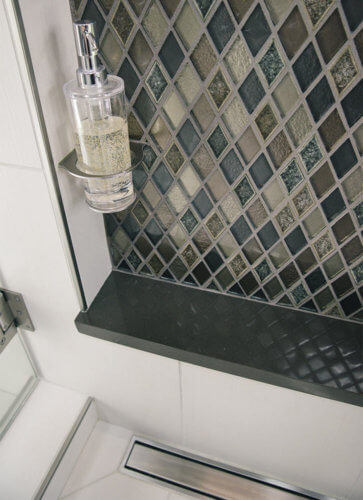 diamond tile and built-in soap bottle holder in contemporary master suite shower in Granger Iowa by Silent Rivers Design+Build