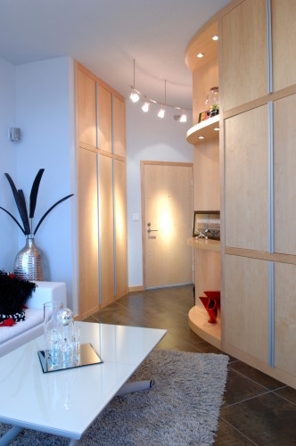 Curved wall of cabinets is a useful accent in this small condo