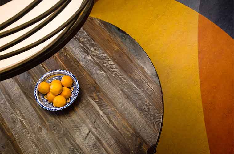 Reclaimed wood table and Marmoleum flooring in a contemporary kitchen remodel in Des Moines designed by Silent Rivers