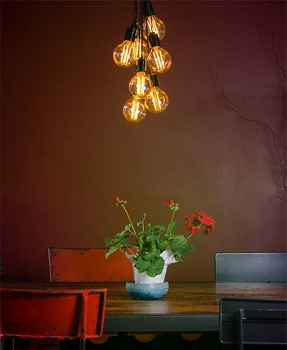 Custom light fixture made of LED filament bulbs and gas pipe in a downtown Des Moines loft designed by Silent Rivers