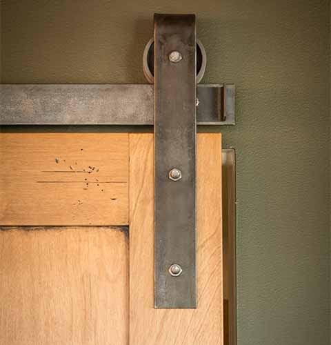 A custom-built barn door in a downtown Des Moines loft remodel by Silent Rivers