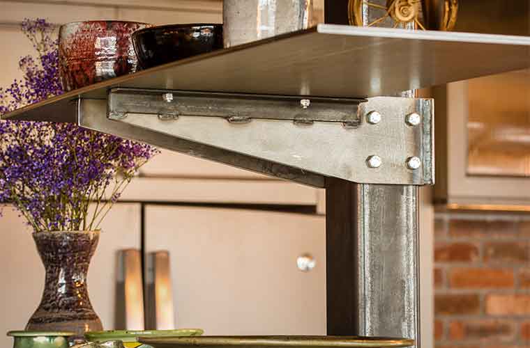 Custom-made steel shelf in a downtown Des Moines loft remodeled by Silent Rivers