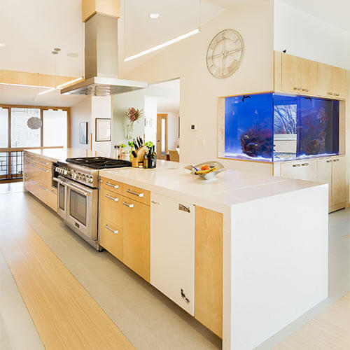 Johnston Iowa contemporary midcentury kitchen remodel by Silent Rivers, view toward built-in 650-gallon saltwater aquarium