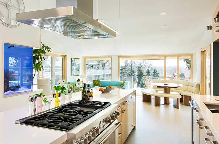 Johnston Iowa contemporary midcentury kitchen remodel by Silent Rivers, looking toward cooktop and banquette breakfast nook