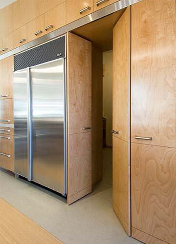 Johnston Iowa contemporary midcentury kitchen remodel by Silent Rivers with walk-in pantry that repurposes former kitchen cabinets