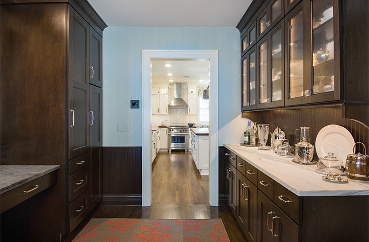 Butler's pantry adjacent to white kitchen designed by Silent Rivers in a historic Des Moines colonial farmhouse