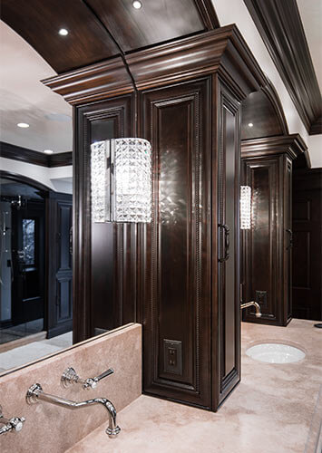 Urbandale-Iowa-luxurious-traditional-master-bedroom-by-Silent-Rivers with arches, custom millwork and cabinets, crystal sconces, wall-mounted faucets