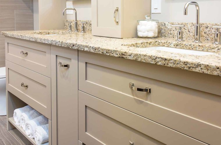 Modernized 1980s bathroom with custom double vanity, tall faucets, granite counter by Silent Rivers, Des Moines, Iowa