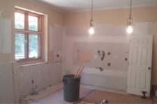 Kitchen remodeling during construction by Silent Rivers of Des Moines. Cabinets and appliances have been stripped.