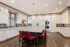 Large kitchen remodel by Silent Rivers in Clive, Iowa features custom cabinetry, large island, upper display cabinets