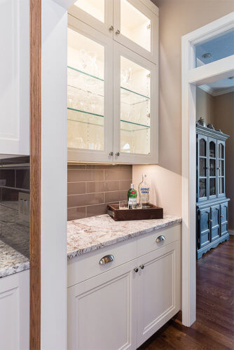 Passthrough bar and butler's pantry area adjacent to kitchen and dining room by remodeler Silent Rivers in Clive, Iowa