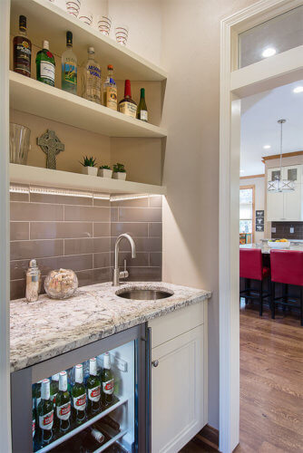Passthrough bar area adjacent to kitchen by remodeler Silent Rivers in Clive, Iowa