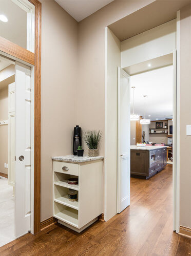 walk-in pantry in large Clive, Iowa kitchen by remodeler Silent Rivers features charging station