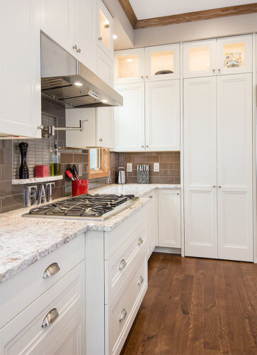 Transitional kitchen remodel in Clive, Iowa features drawers beneath the range for storing pots and pans by remodeler Silent Rivers