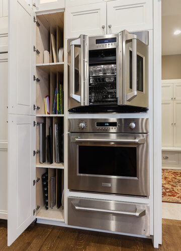french door double oven and custom storage tower for cookie sheets and cutting boards in Clive, Iowa kitchen remodel by Silent Rivers
