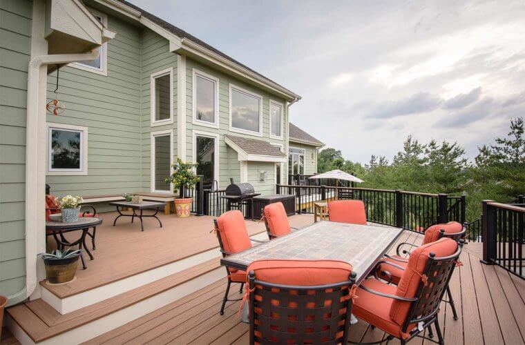 upper composite deck with multiple levels and curved railing by builder Silent Rivers of Des Moines, Iowa