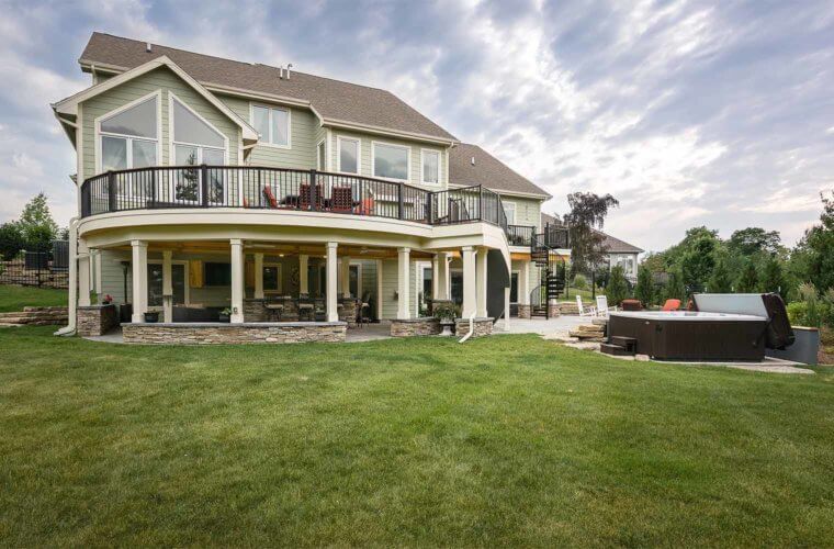 backyard makeover_backyard view of curved deck and patio with spa by builder Silent Rivers, Des Moines, Iowa
