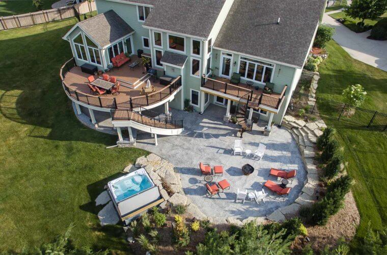 backyard makeover_aerial photo of curved deck, patio and spa by outdoor designer and builder Silent Rivers of Des Moines, Iowa