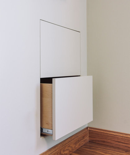 transition white and gray remodel of 1980s galley small kitchen in Des Moines by designer builder Silent Rivers features hidden drawers