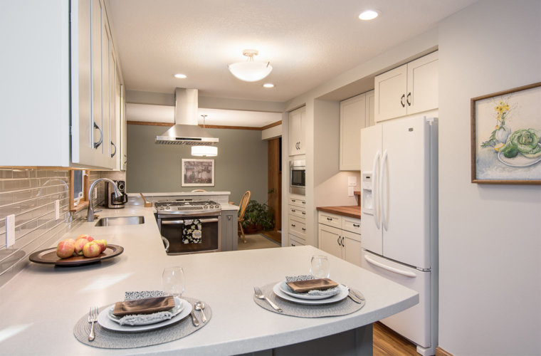 transition white and gray remodel of 1980s galley small kitchen in Des Moines by designer builder Silent Rivers