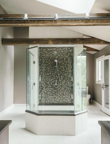 glass enclosed centralized hexagonal shower in bathroom remodel by Silent Rivers of Des Moines