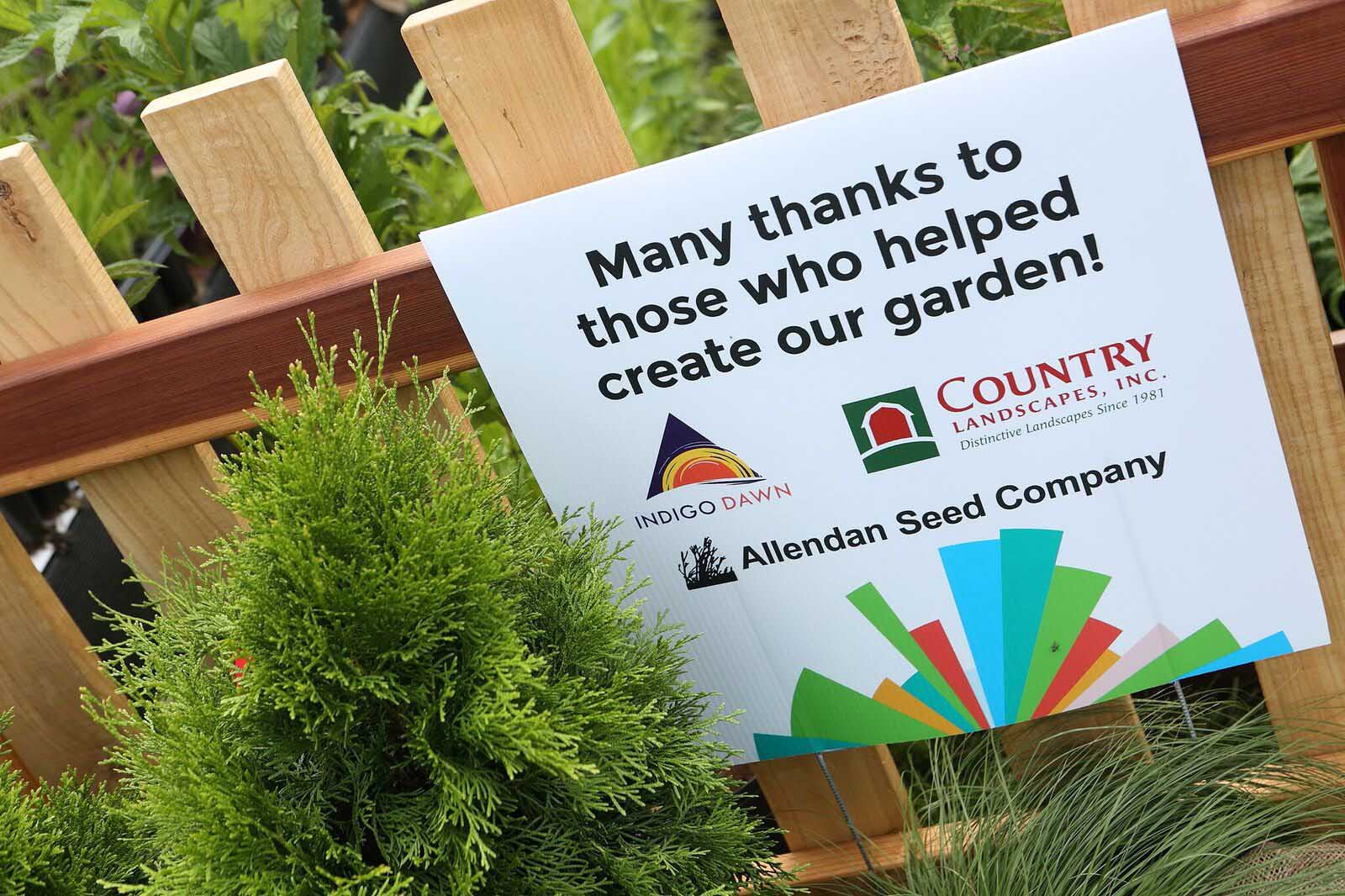 Garden sign for Silent Rivers VIP Club at 2018 Des Moines Arts Festival with sustainable materials and garden