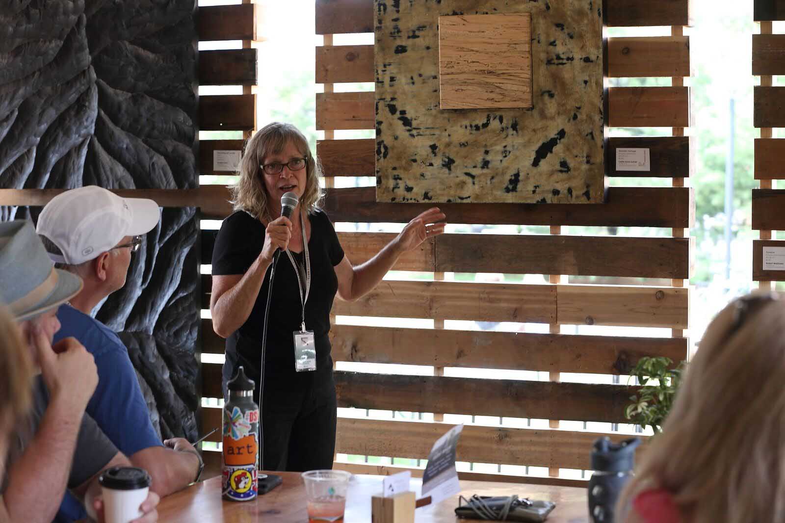 Leslie Ann Guinean, Hidden Springs artist, DMAF Curated exhibit and presentations in the Creative Cafe area of the Silent Rivers VIP Club at the 2018 Des Moines Arts Festival